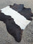 A large black and white natural cowhide rug with soft fluffy texture showcasing unique characteristics for beautiful rugs
