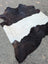 A large black and white belted galloway cowhide rug with soft fluffy texture and unique characteristics perfect for beautiful rugs