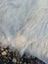 A large cowhide style soft fluffy white faux fur blanket with dense wavy texture perfect for unique beautiful rugs