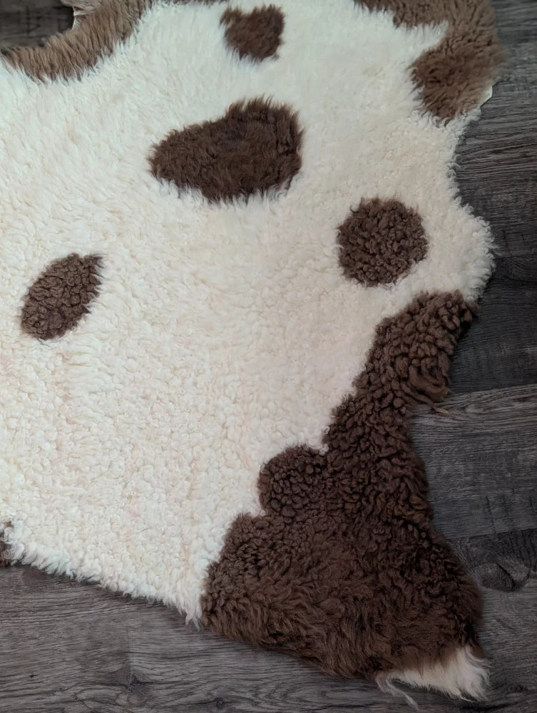 Cream-colored tibet highland spotted sheepskin rug with fluffy brown spots grade a- sheepskins perfect for cozy decor