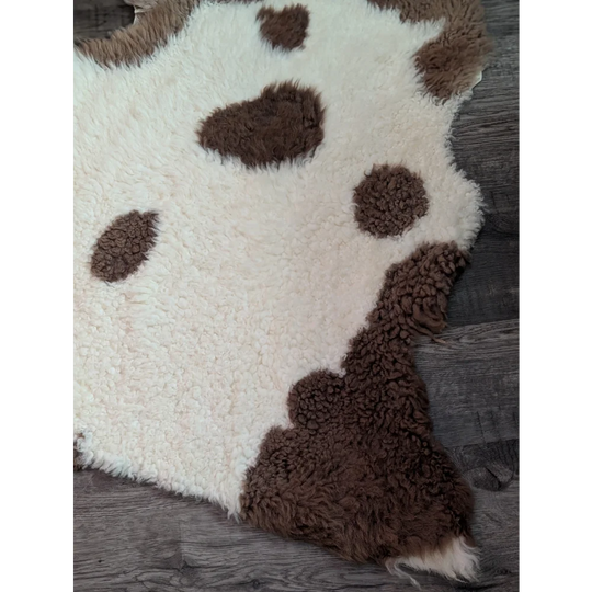 Cream-colored tibet highland spotted sheepskin rug with fluffy brown spots grade a- sheepskins perfect for cozy decor
