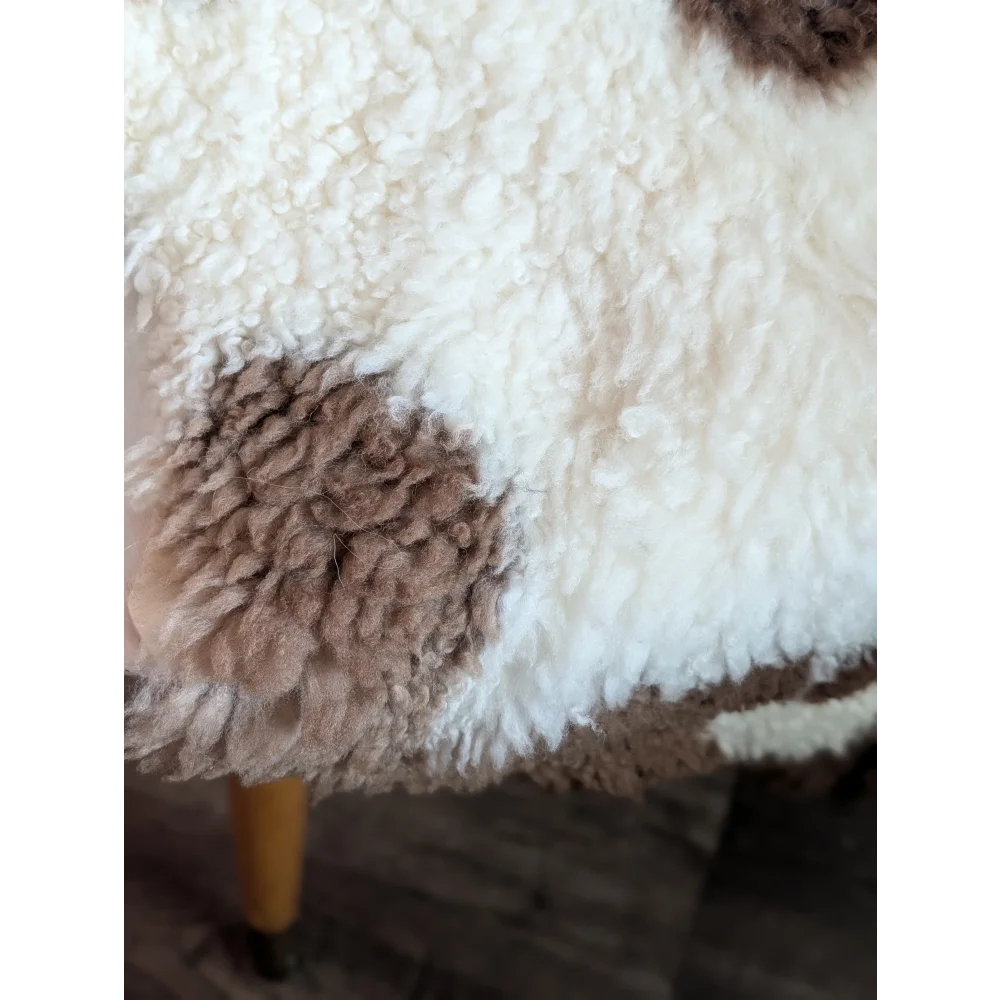 White and brown fluffy highland spotted sheepskin blanket grade a- with soft textured surface for cozy use