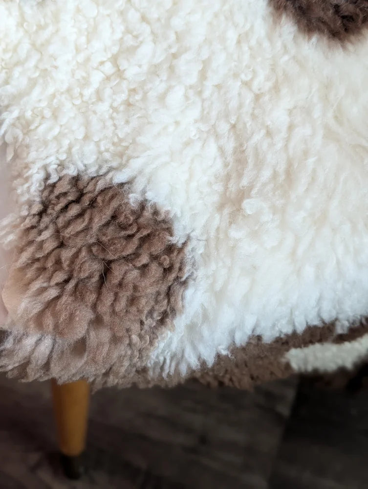 White and brown fluffy highland spotted sheepskin blanket grade a- with soft textured surface for cozy use