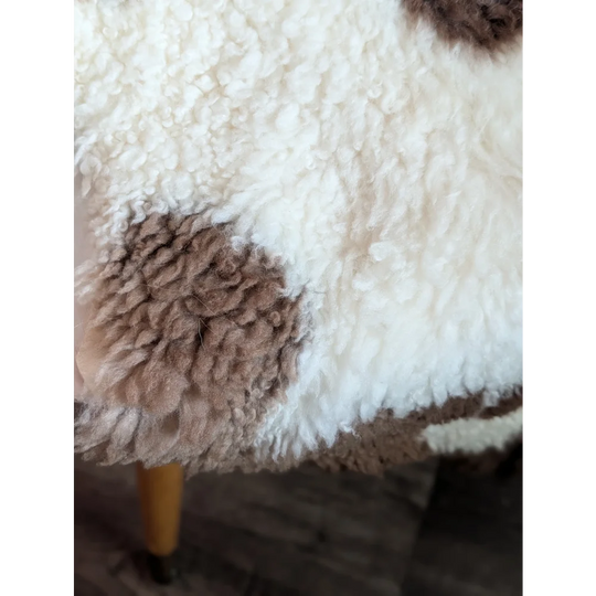 White and brown fluffy highland spotted sheepskin blanket grade a- with soft textured surface for cozy use
