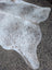 Large grey mix cowhide rug with unique speckled gray and white patterns and rustic charm, measuring 89 by 77 inches