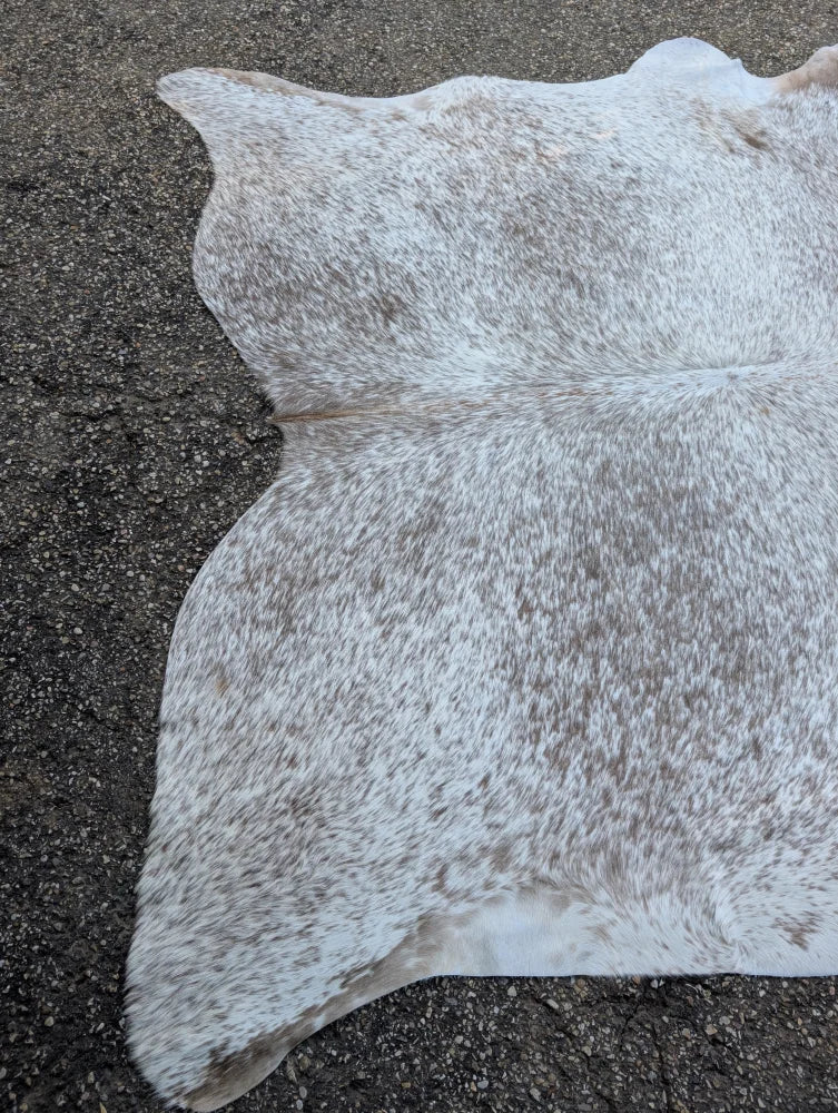 Large cowhide rug in grey mix with natural white and gray speckled pattern offering unique characteristics and rustic charm