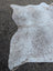 Large cowhide rug in grey mix with natural white and gray speckled pattern offering unique characteristics and rustic charm