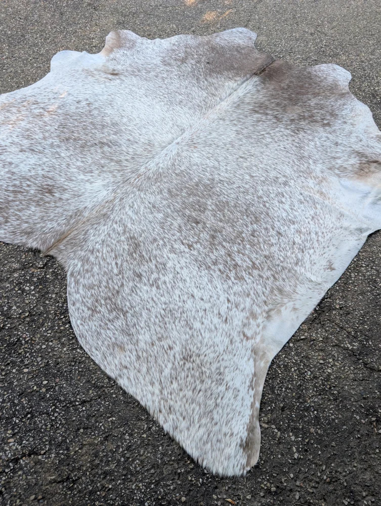 Large 89 x 77 natural white and gray speckled cowhide rug with unique characteristics and rustic charm