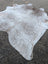 Large 89 x 77 natural white and gray speckled cowhide rug with unique characteristics and rustic charm