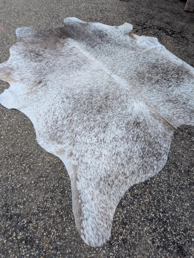 Large cowhide rug 89 x 77 with unique gray and white mottled pattern adds rustic charm to any space