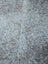 Large gray and white speckled cowhide rug with unique characteristics and rustic charm measuring 89 by 77 inches