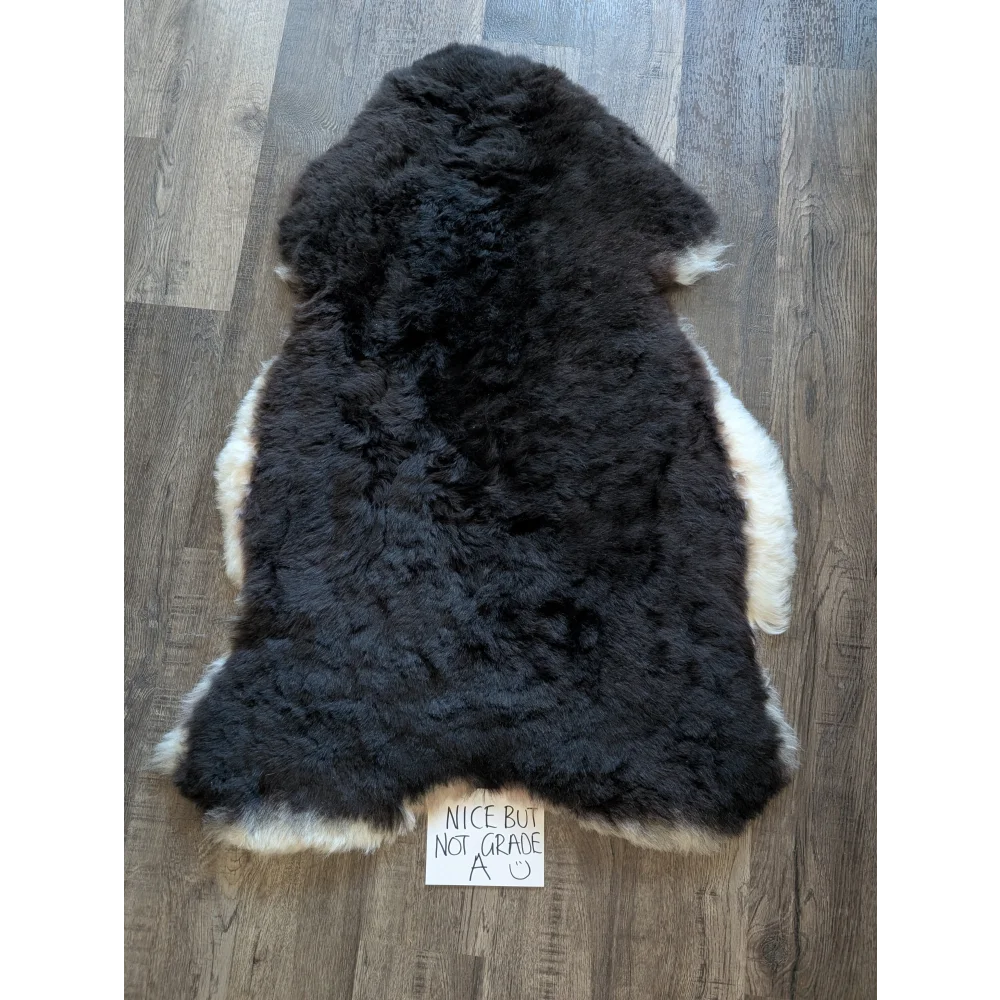 Black and white standard grade short wool white icelandic sheepskin rug with fluffy plush texture