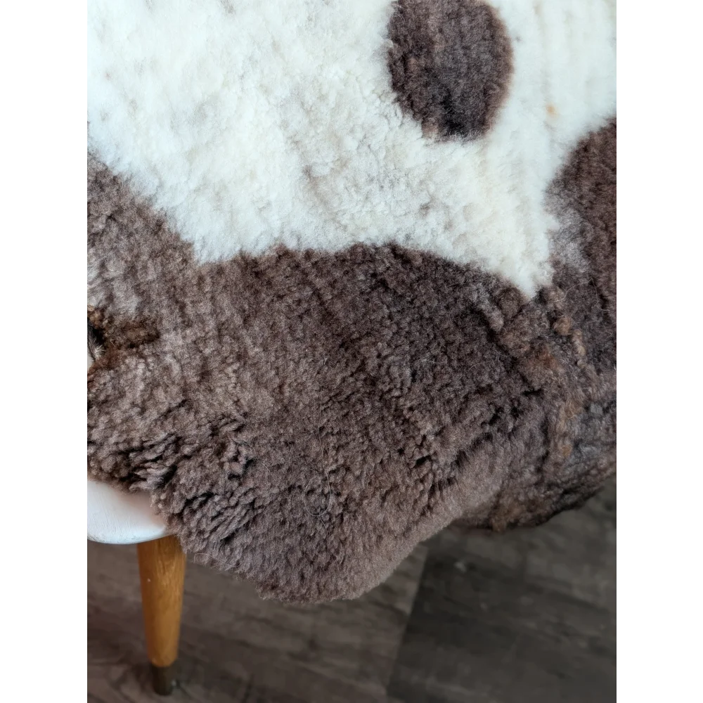 A plush two-toned highland spotted sheepskin rug in soft white and rich brown grade a- sheepskins