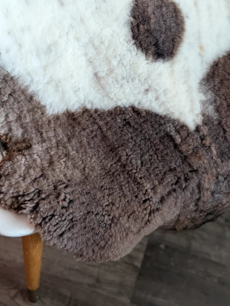 A plush two-toned highland spotted sheepskin rug in soft white and rich brown grade a- sheepskins