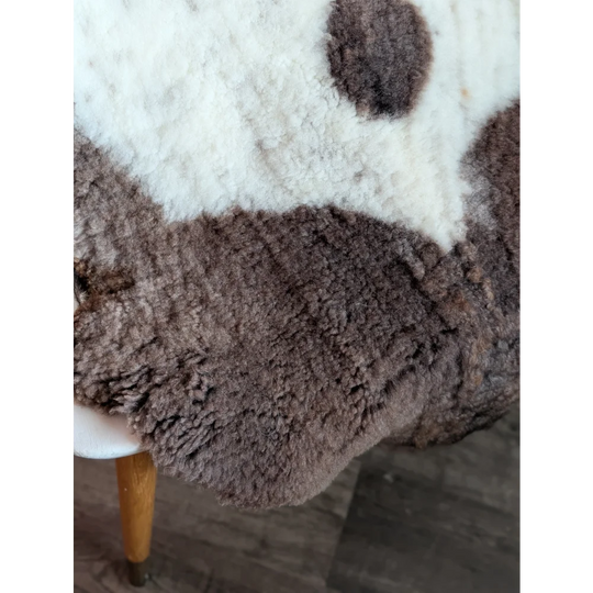 A plush two-toned highland spotted sheepskin rug in soft white and rich brown grade a- sheepskins