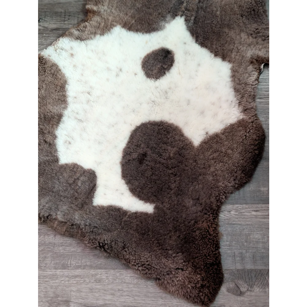 Brown and white highland spotted grade a- sheepskin rug with natural irregular shape for cozy home decor
