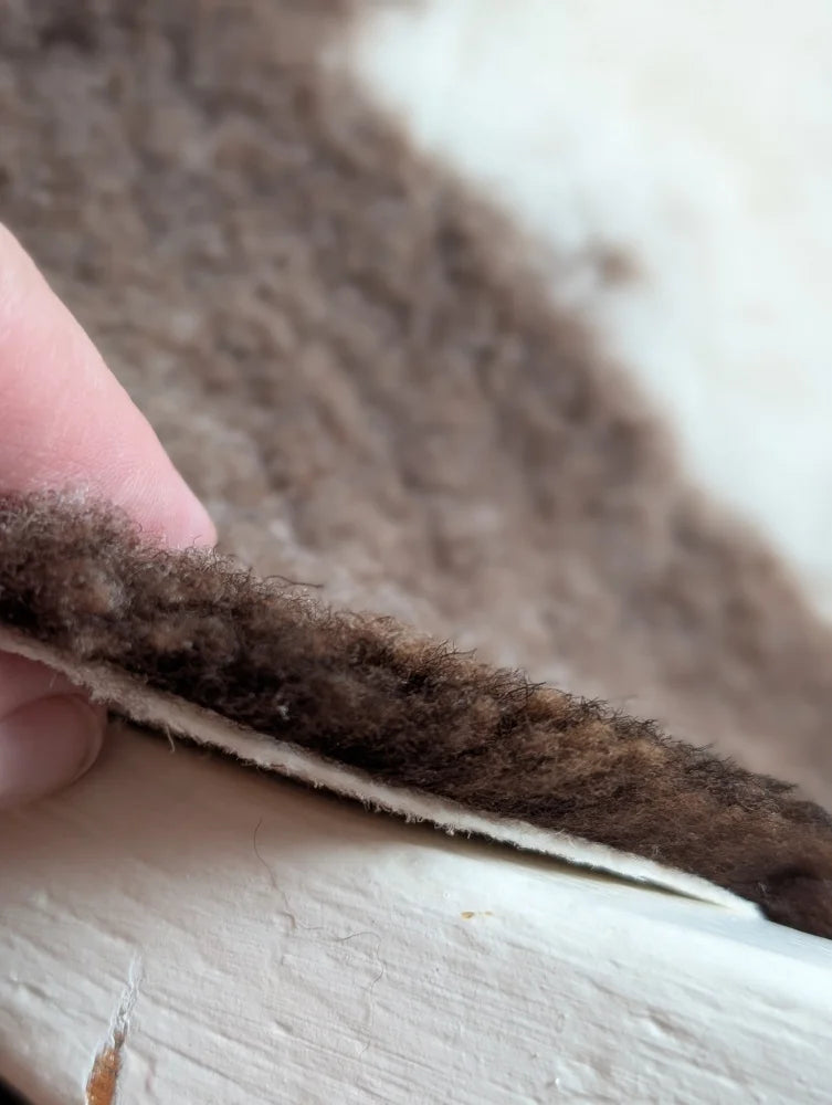 Brown fluffy highland spotted sheepskin insole with soft textured surface and visible stitching grade a- sheepskins