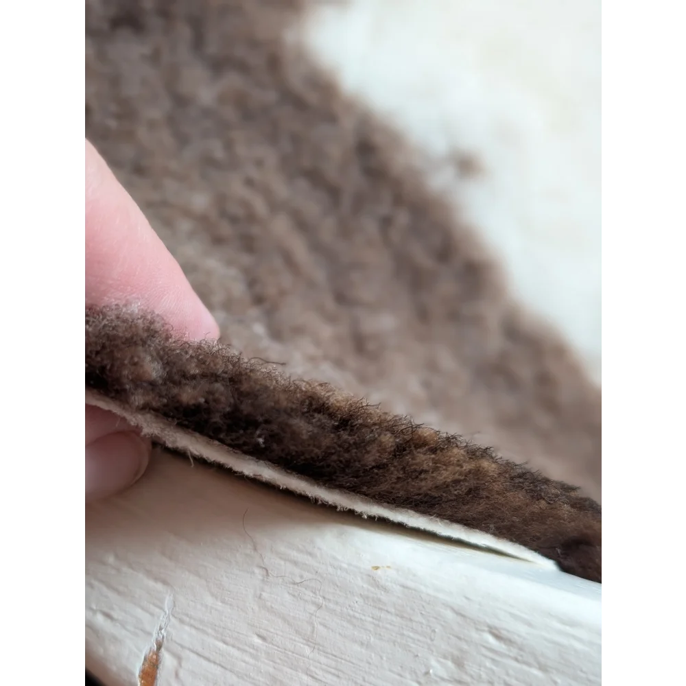 Brown fluffy highland spotted sheepskin insole with soft textured surface and visible stitching grade a- sheepskins