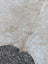 Large beige and white speckled cowhide rug with soft natural fur texture and unique characteristics adding rustic charm
