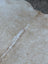 Beige and white speckled large cowhide rug with natural fur texture showcasing unique characteristics and rustic charm