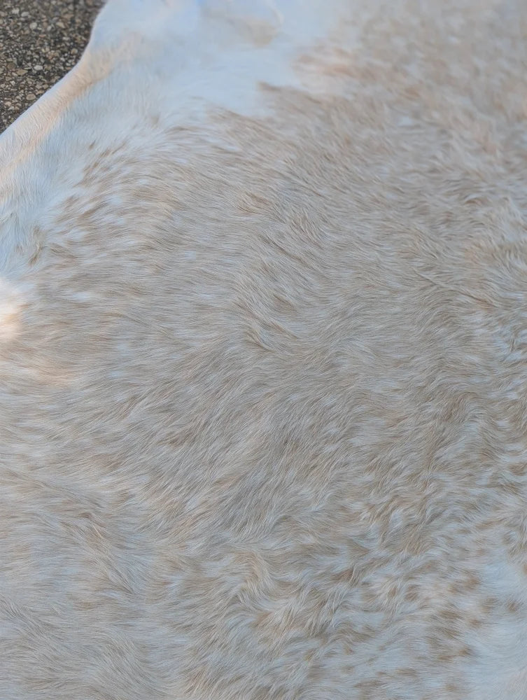 Large cowhide rug 98 x 89 with rustic charm featuring soft natural tones and unique characteristics in beige and white