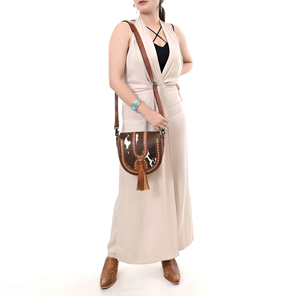Gorgeous hair-on cowhide cross body bag with tan trim and tassel