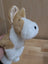A soft plush adorable corgi puppy puppet with tan and white fur and stitched black eyes and nose