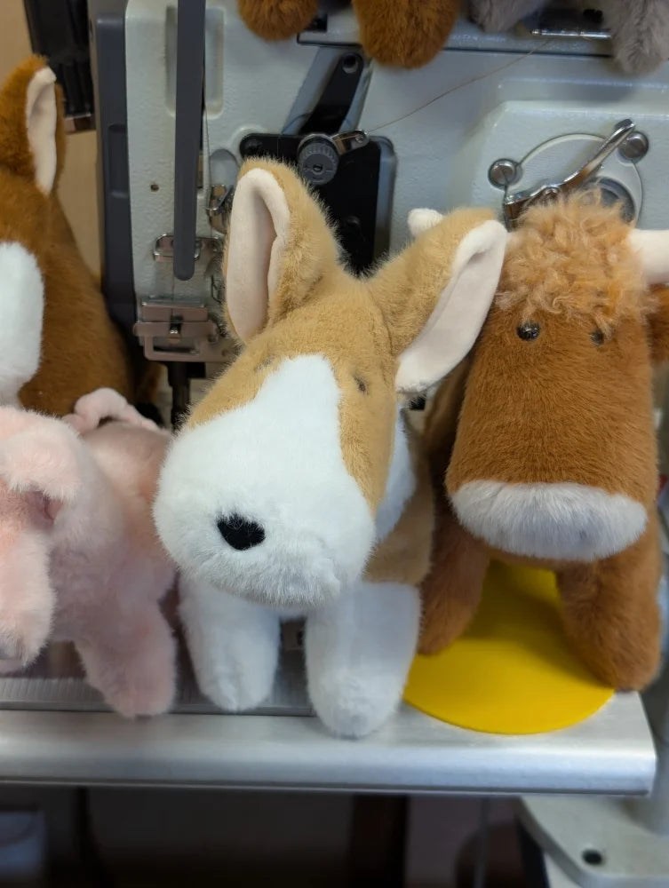 Adorable corgi plush dog toy with soft tan and white fur black button eyes and stitched nose for cuddling