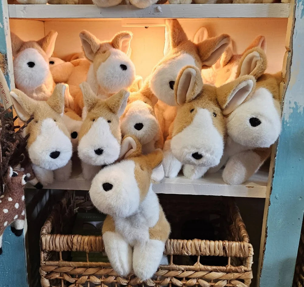 Adorable corgi plush toy with tan and white fur and black button eyes perfect for cuddling and decorating