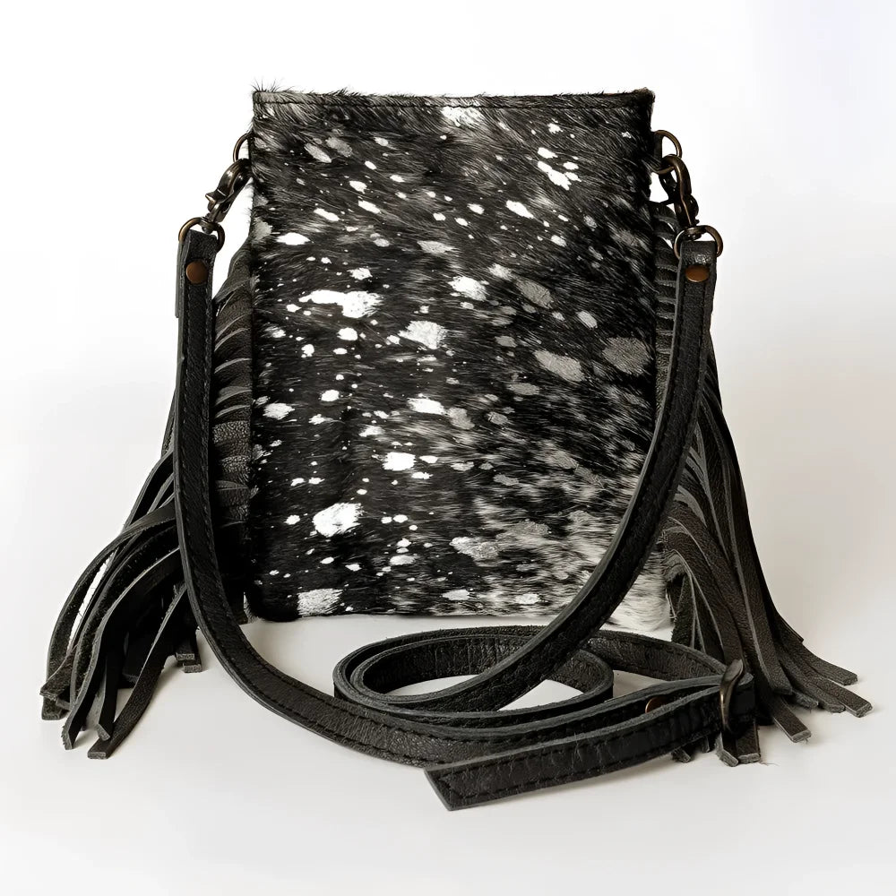 Black and white speckled genuine leather Chaps cowhide crossbody bag with fringe straps. Canada