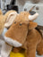 Adorable highland cow plush toy in tan with white accents on muzzle and horns perfect for cuddling and decor