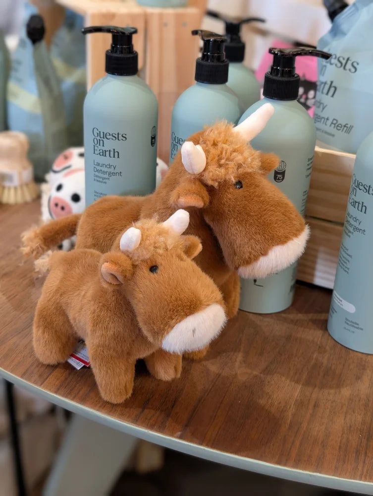 Brown plush highland cow stuffed toy with white horns and snouts soft fur and fluffy head fluff for cuddling