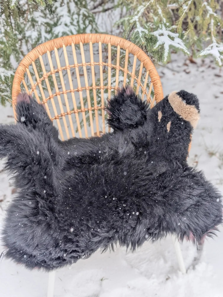 Adorable merino sheepskin black bear rug handmade with black fluffy fur and tan accents on ears and paws