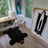 Adorable merino sheepskin black bear rug in faux fur with brown snout and paws perfect for cozy decor