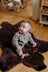 Adorable merino sheepskin grizzly bear rug in dark brown with soft furry texture and black embroidered eyes