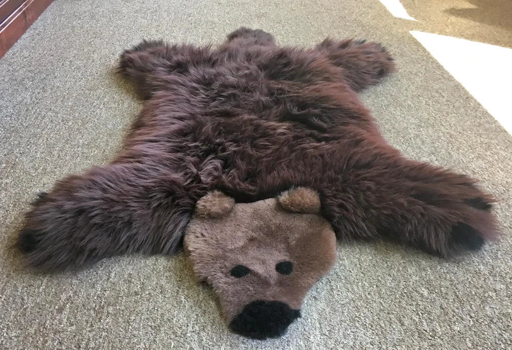 Brown faux fur grizzly bear rug with plush head and black nose made from soft merino sheepskin