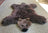 Brown faux fur grizzly bear rug with plush head and black nose made from soft merino sheepskin