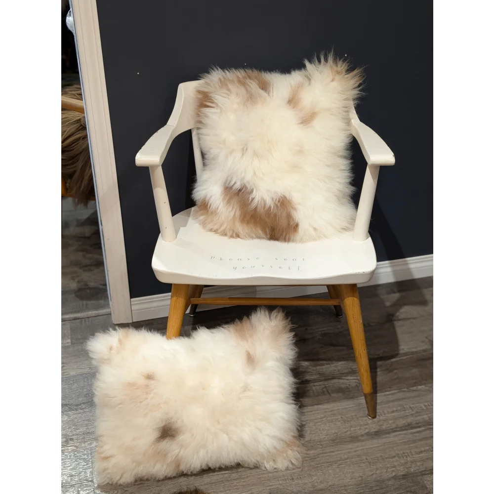 Fluffy cream and beige sheepskin throw pillow on white wooden chair from angus oliver canada sheepskin rugs collection