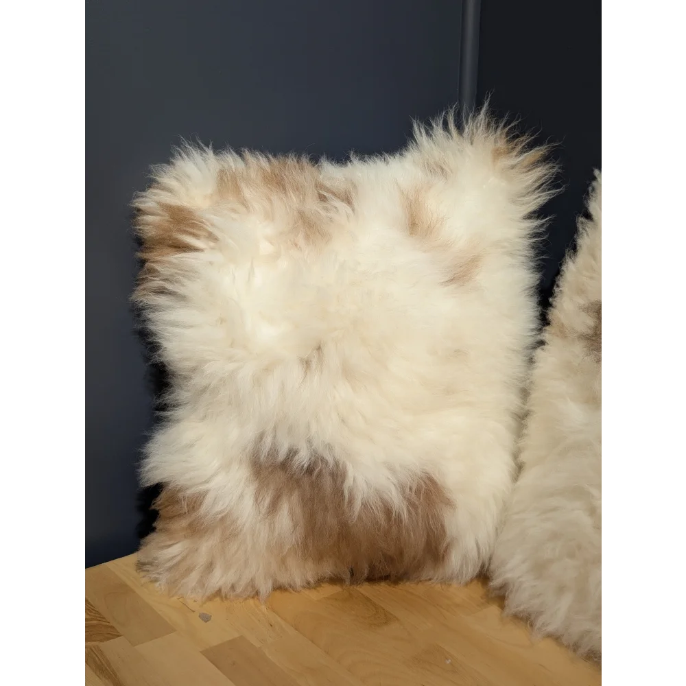 A plush square sheepskin cushion in cream and light brown perfect for cozy angus oliver canada decor