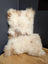 A plush cream and beige sheepskin cushion with a soft textured surface from angus oliver canada collection