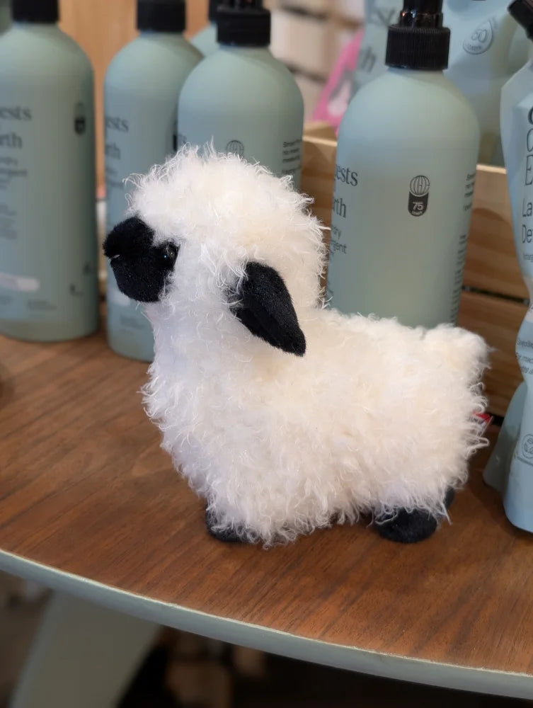 Adorable shilo the mini sheep soft toy is a fluffy white plush lamb with black ears nose and feet