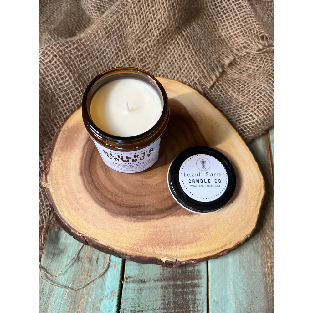 White Alberta Cowboy Candle with black label on wooden base