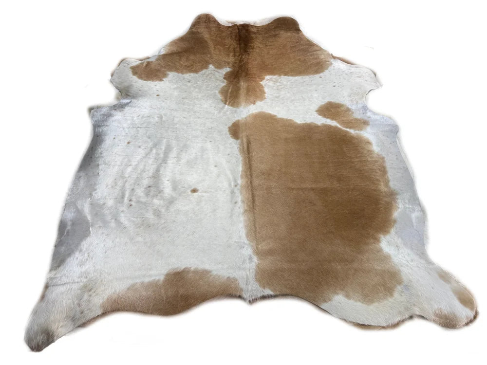 Brown and white large cowhide rug with natural fur texture showcasing unique characteristics beautiful rugs arriving soon