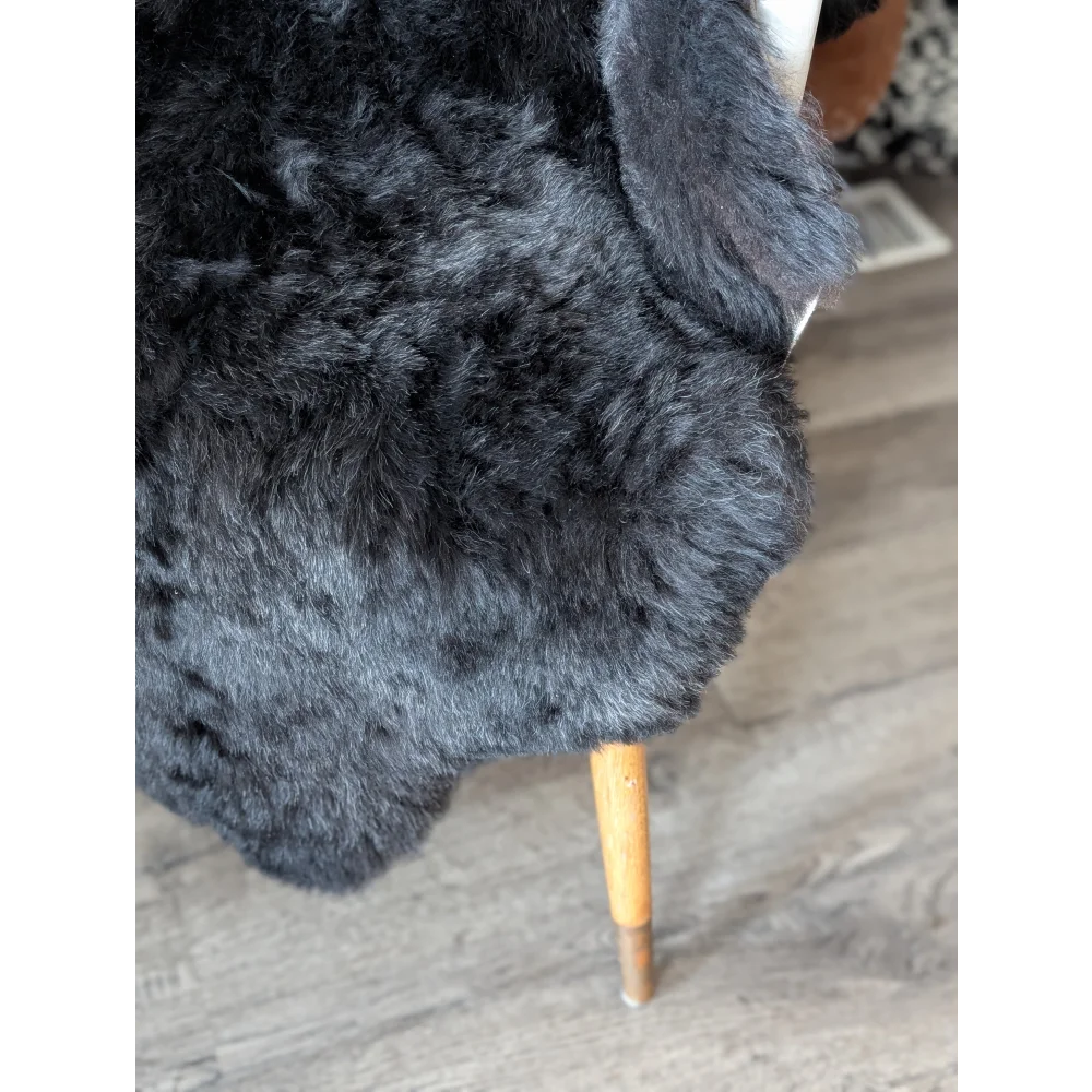 Soft Icelandic sheepskin rug draped over wooden chair leg