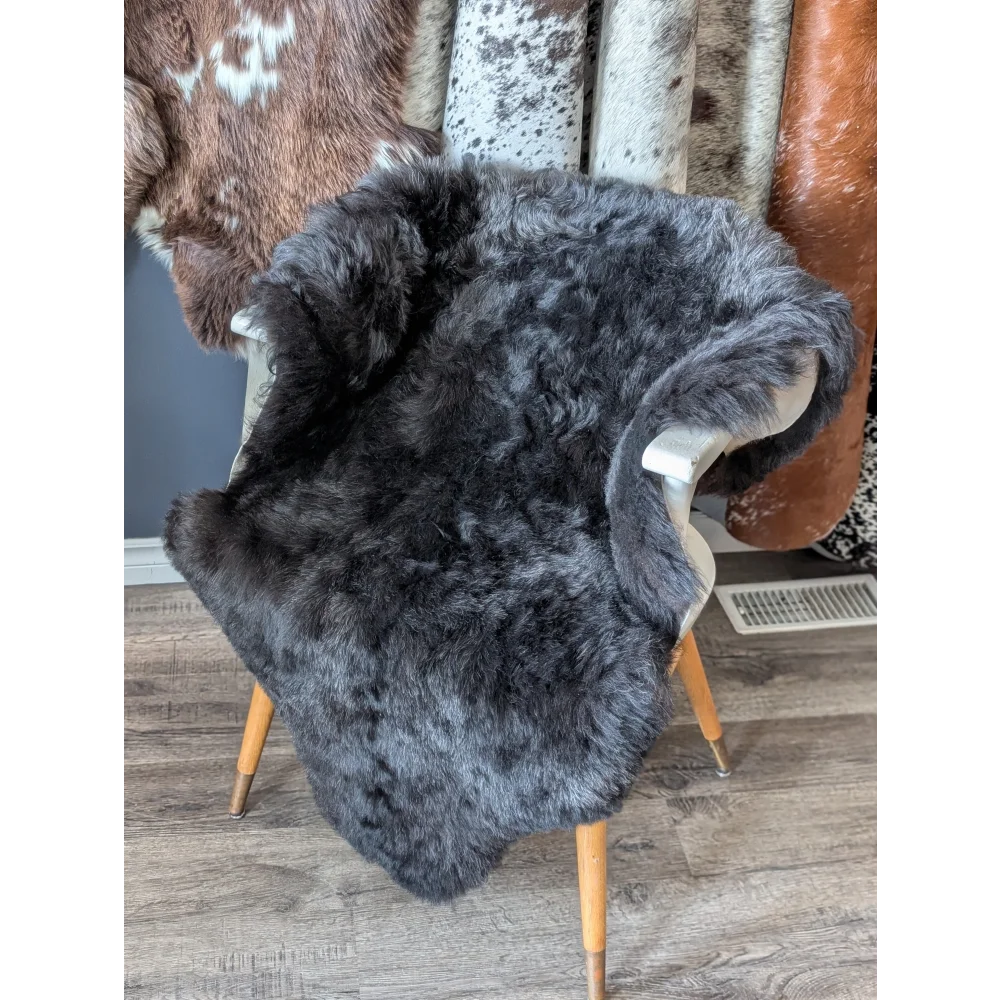 Soft Icelandic sheepskin rug 47x33in draped over white chair back