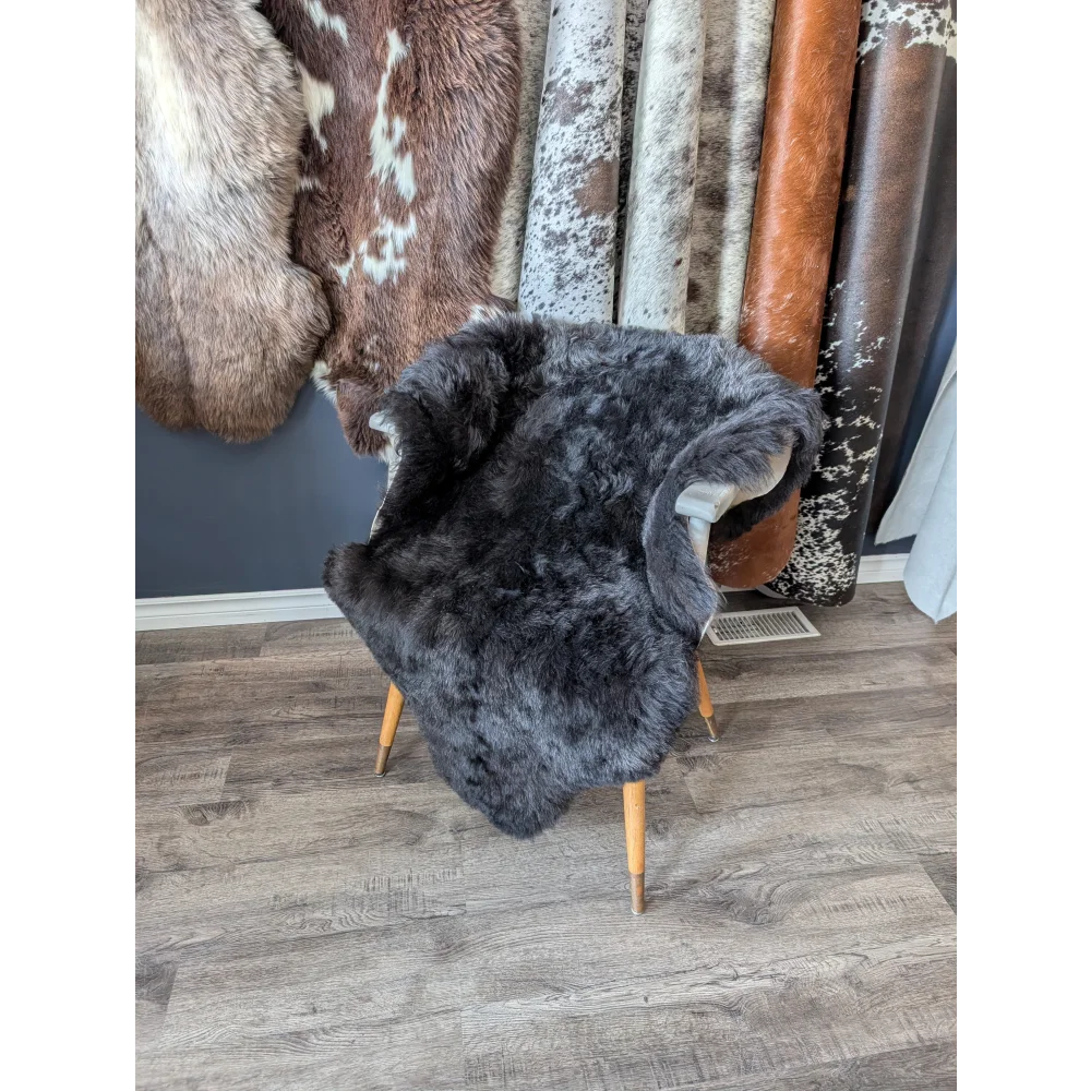 Dark gray soft Icelandic sheepskin rug 47x33 inches on wooden chair