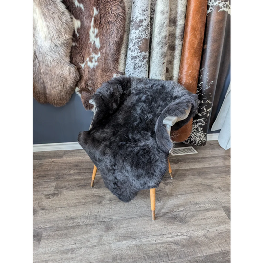 Dark gray soft Icelandic sheepskin rug 47x33 inches on wooden chair