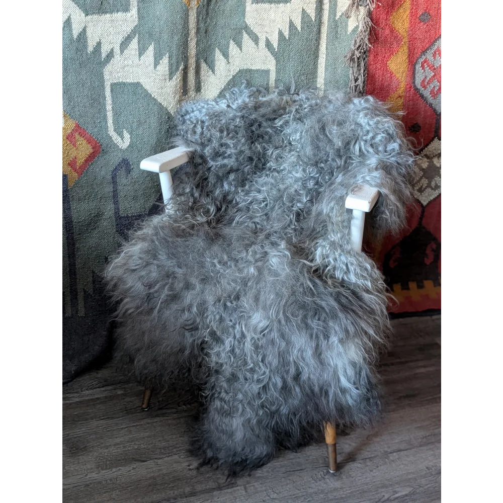 Massive 56x33 Gotland sheepskin rug on white chair with gold legs