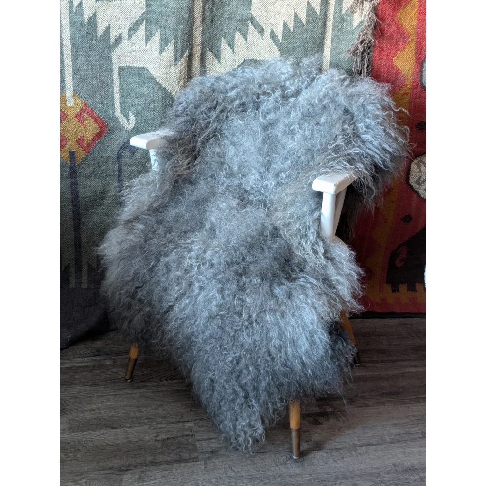 Gotland sheepskin rug, plush gray curly, 54x33 on white chair