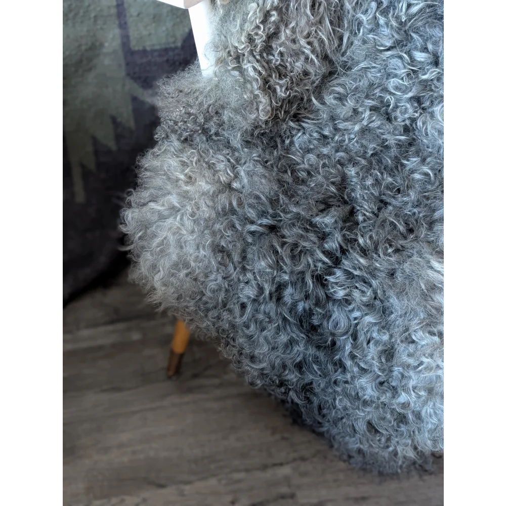 Cozy 50x31 Gotland sheepskin throw draped over chair by Oliver Luxury Sheepskins